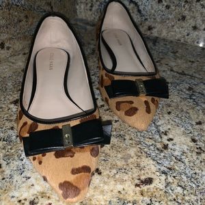 A pair of Cold Haan printed flat shoes